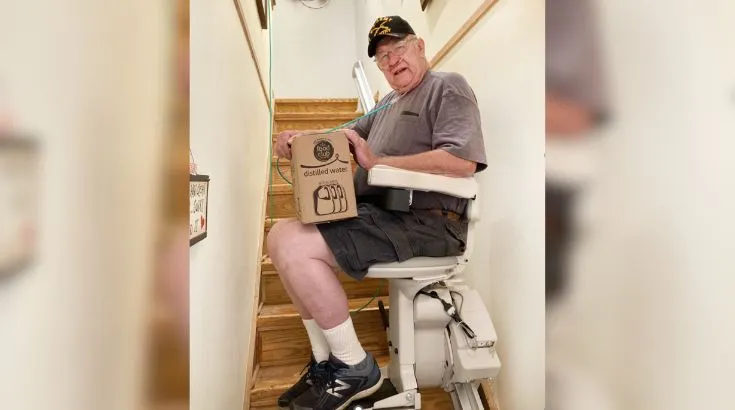 a man riding an indoor stair lift